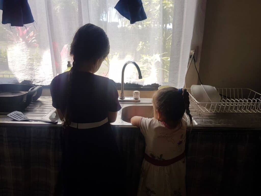little girls washing dishes