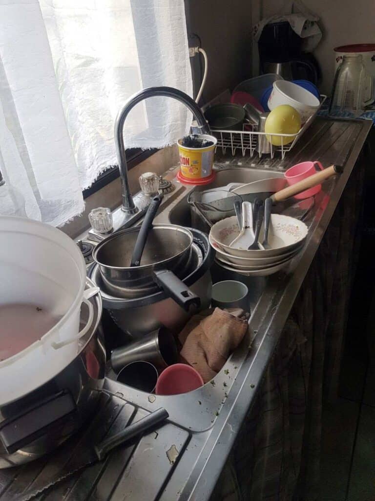 a sink full of dirty dishes