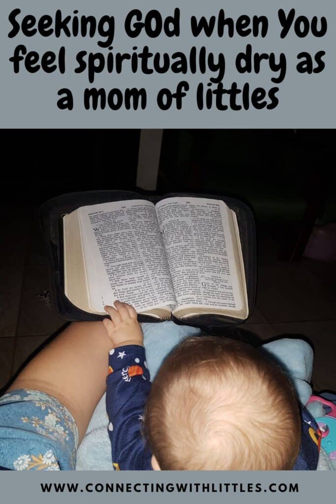 baby reaching for mom's Bible pin