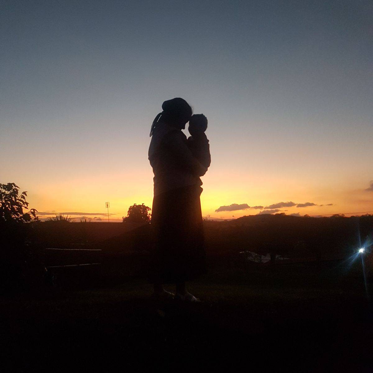 silhouette of mother holding child