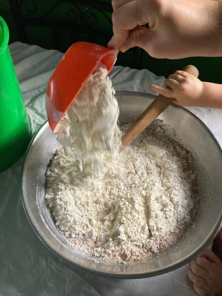 dumping flour into bread dough