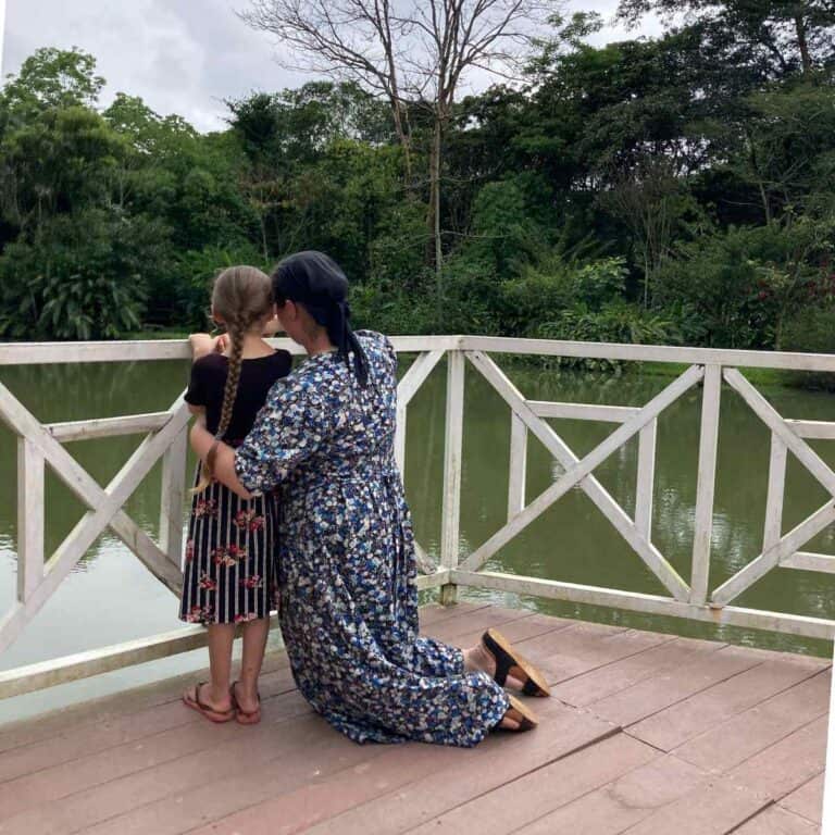 mom and daughter overlooking water