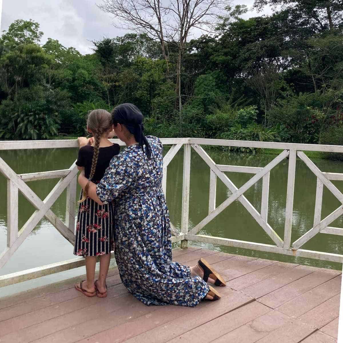 mom and daughter overlooking water