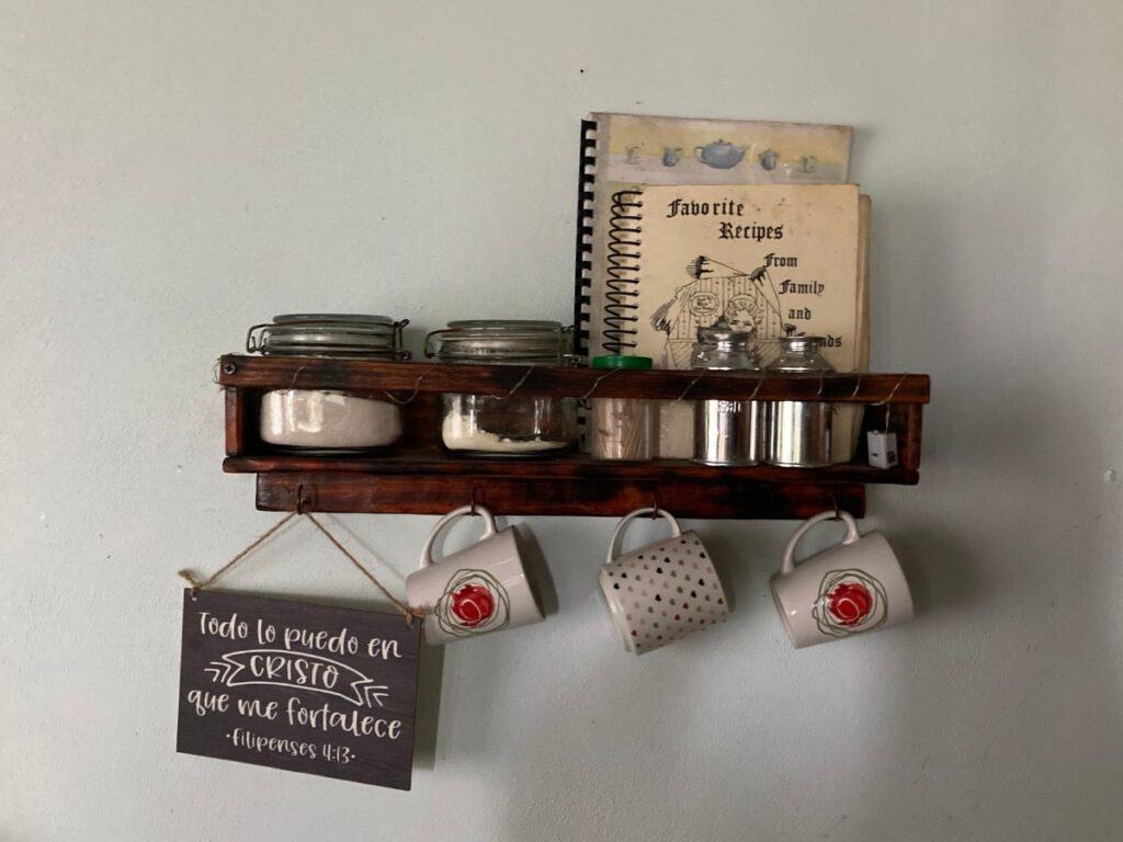small kitchen shelf with cookbooks and coffee mugs